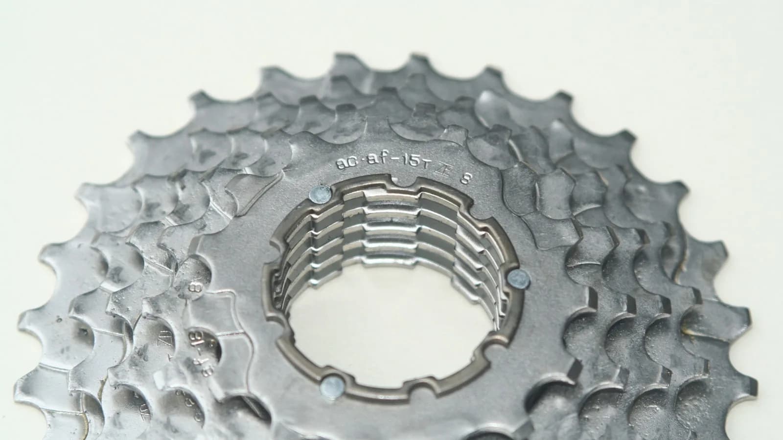 Close-up of a bicycle cassette showing the alignment notch pattern around its center